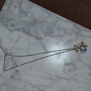 NWOT  charm necklace with anchor, faux tusk, and the word "believe"